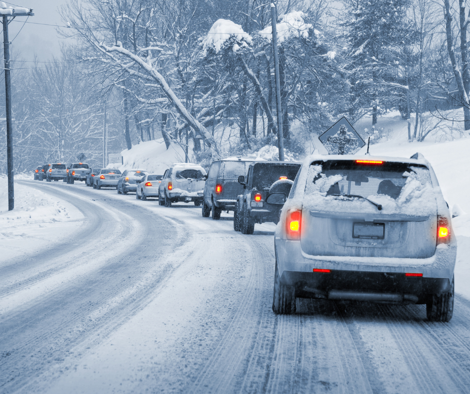 Cars in traffic during snowy weather conditions.